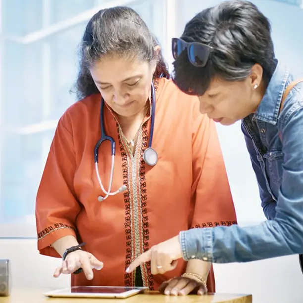 Two women reading a document