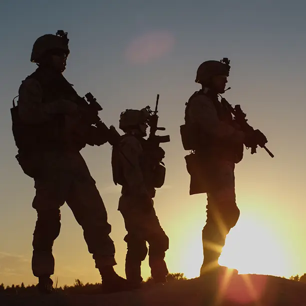 Soldiers standing with the sun in the background