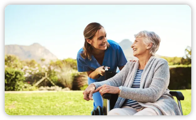 A smiling nurse assisting a smiling woman